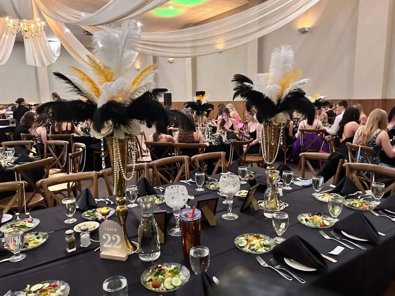 Elegant dining setup with feather centerpieces.