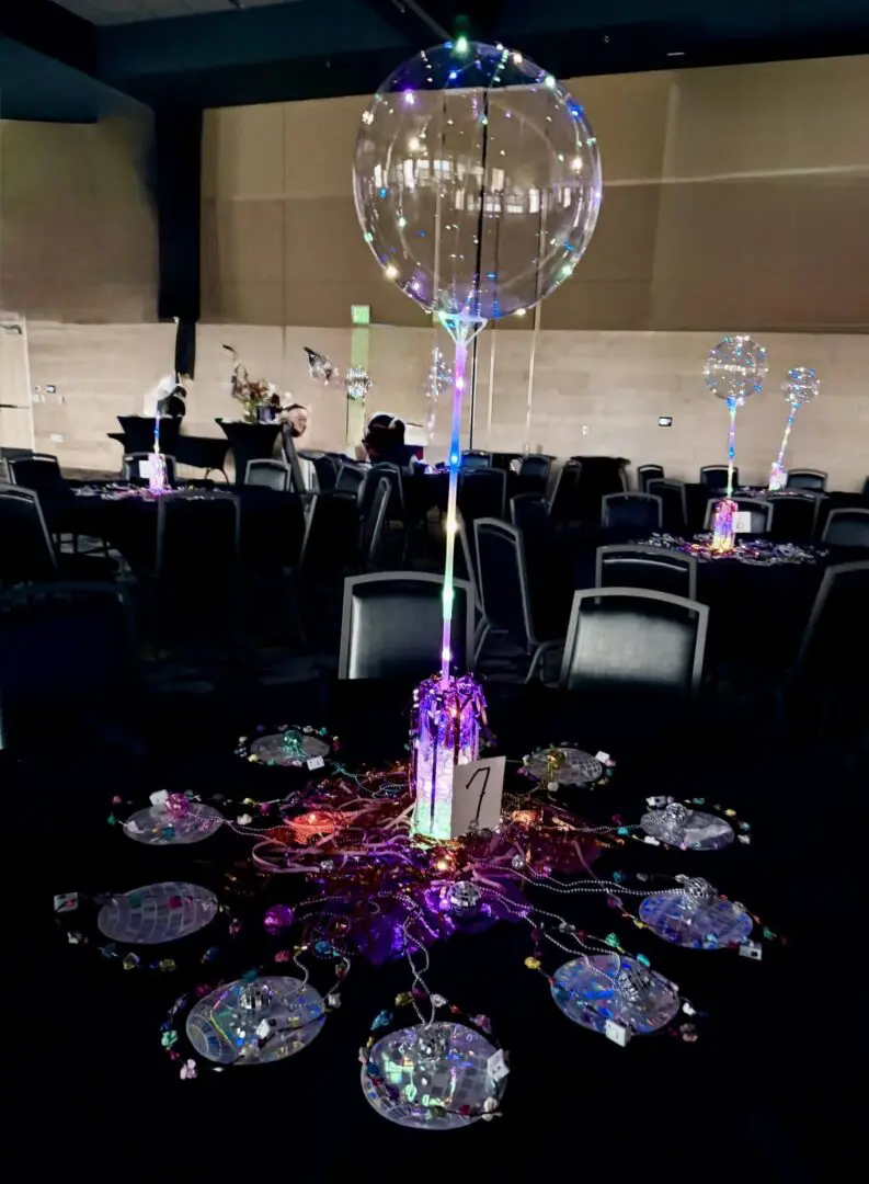Colorful table centerpiece with bubble balloons and decor.