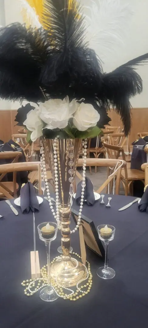 Elegant centerpiece with feathers and roses.
