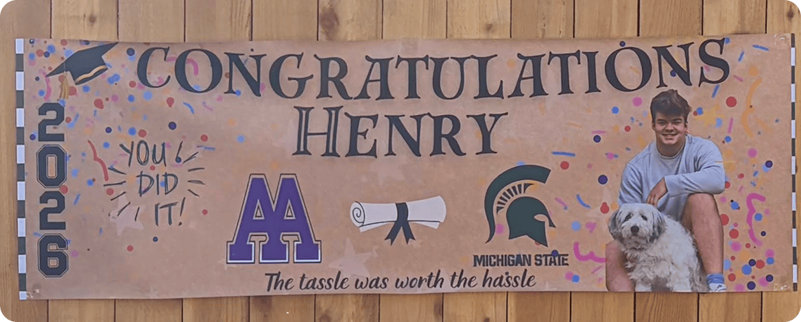 Graduation banner celebrating Henry's achievement with dog.