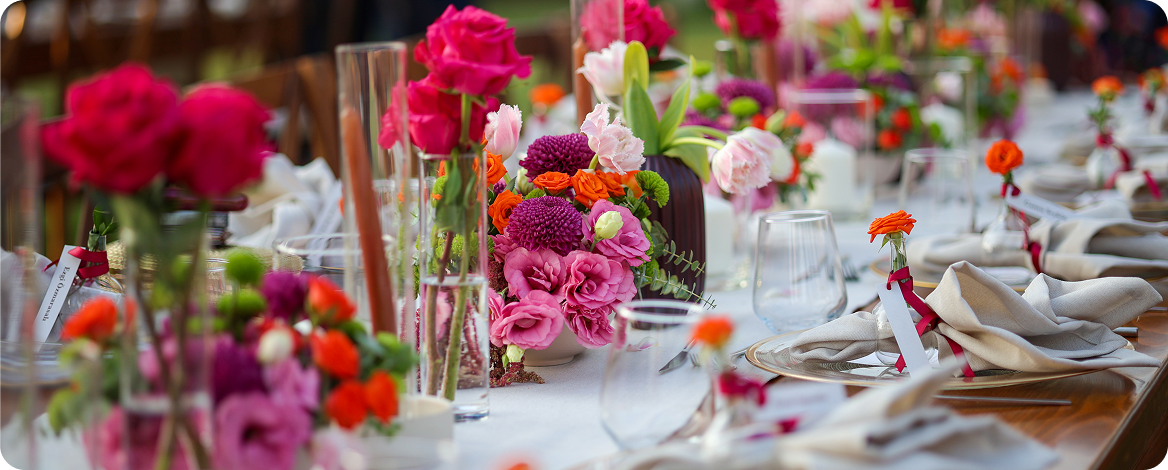 Elegant table setting with vibrant floral arrangements.
