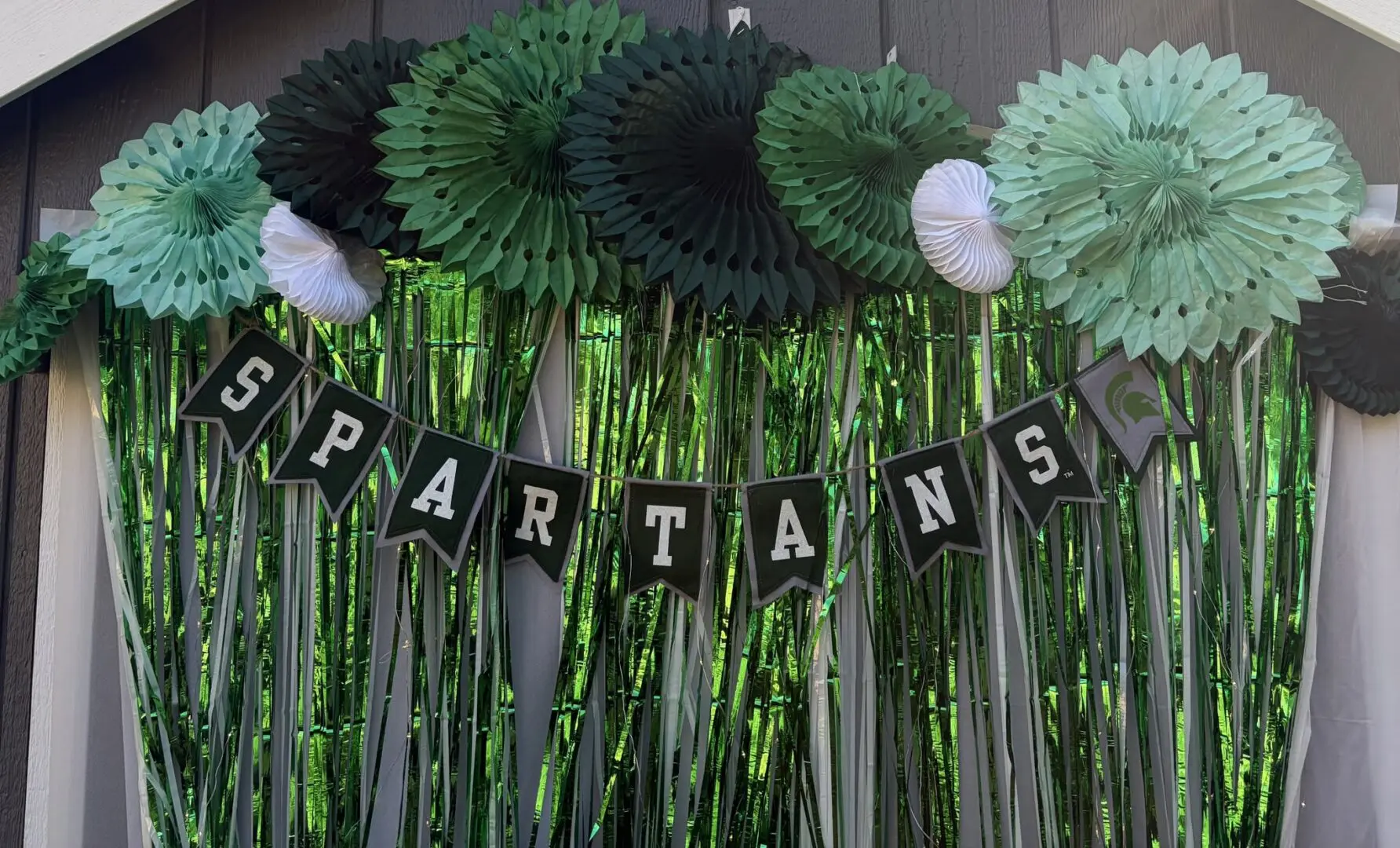 Green and black Spartan-themed festive backdrop.