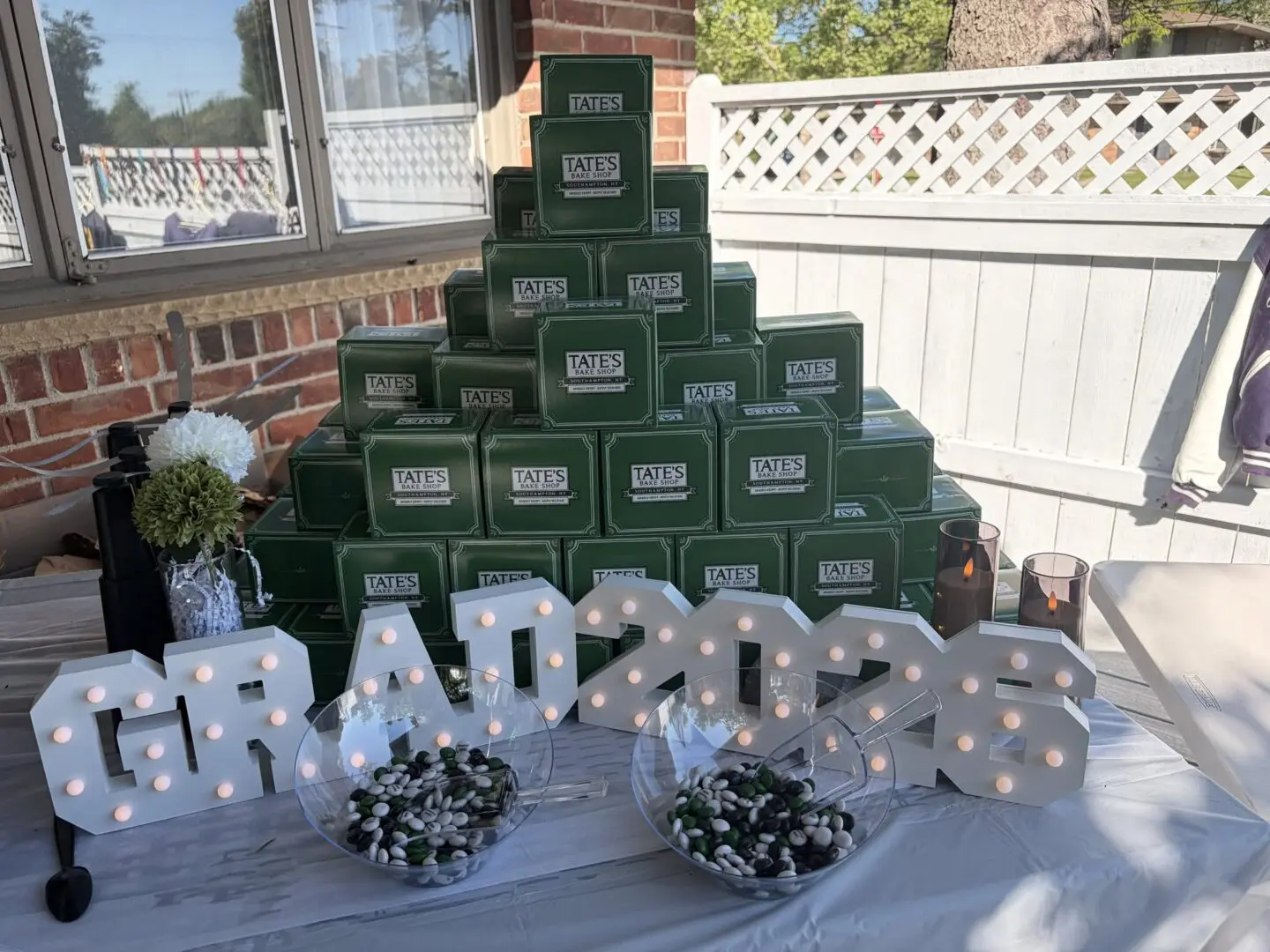 Graduation celebration with decorative boxes and lights.