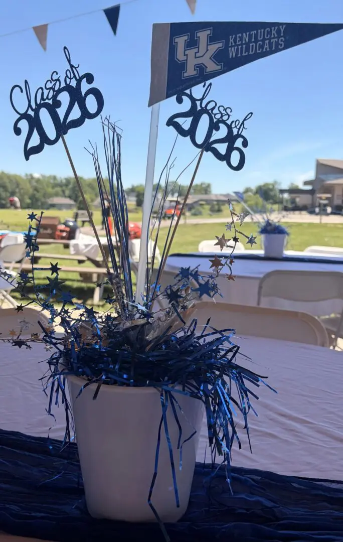 Graduation centerpiece with blue decorations and stars.