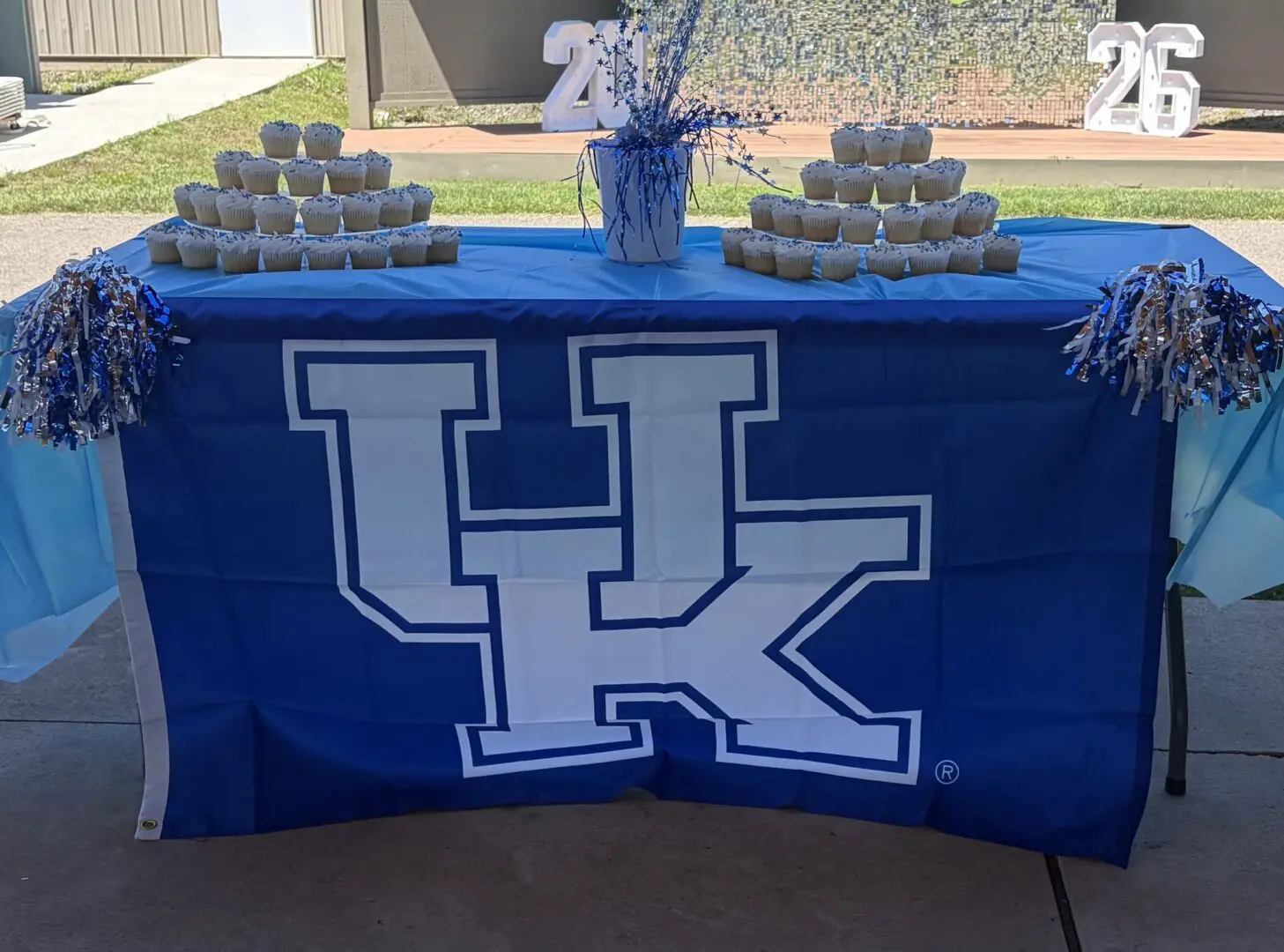 Cupcake display on a blue UK-themed table.