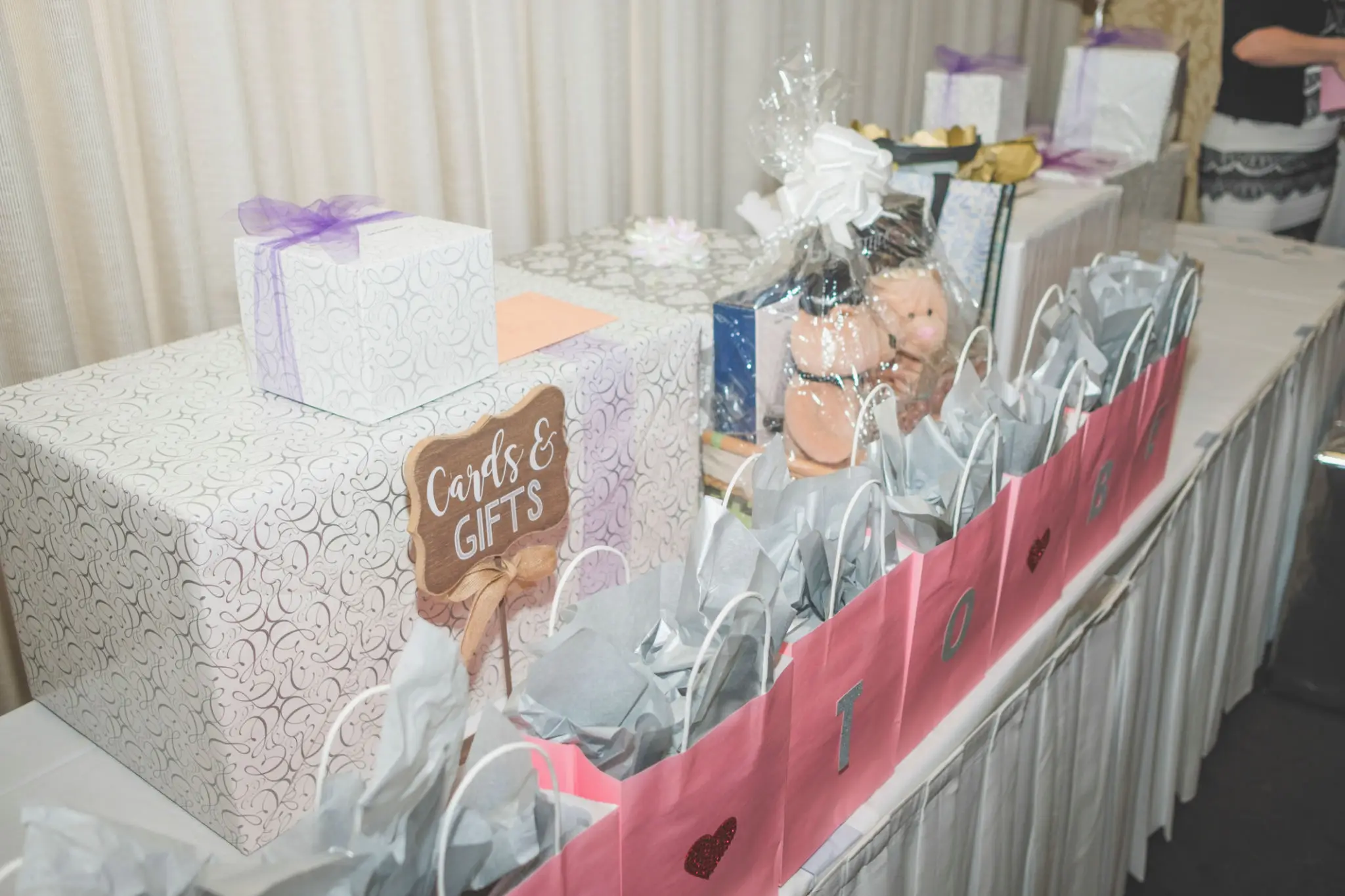 Gift table adorned with decorative boxes and bags.