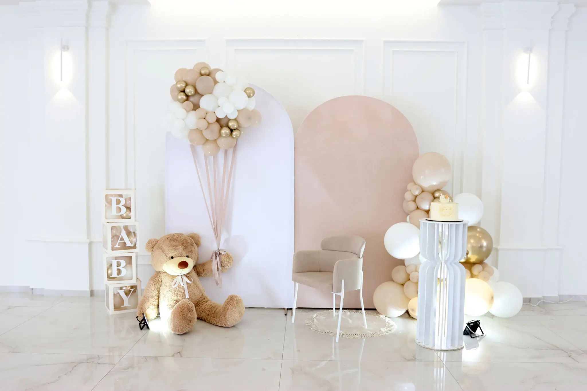 Baby-themed celebration setup with balloons and teddy.