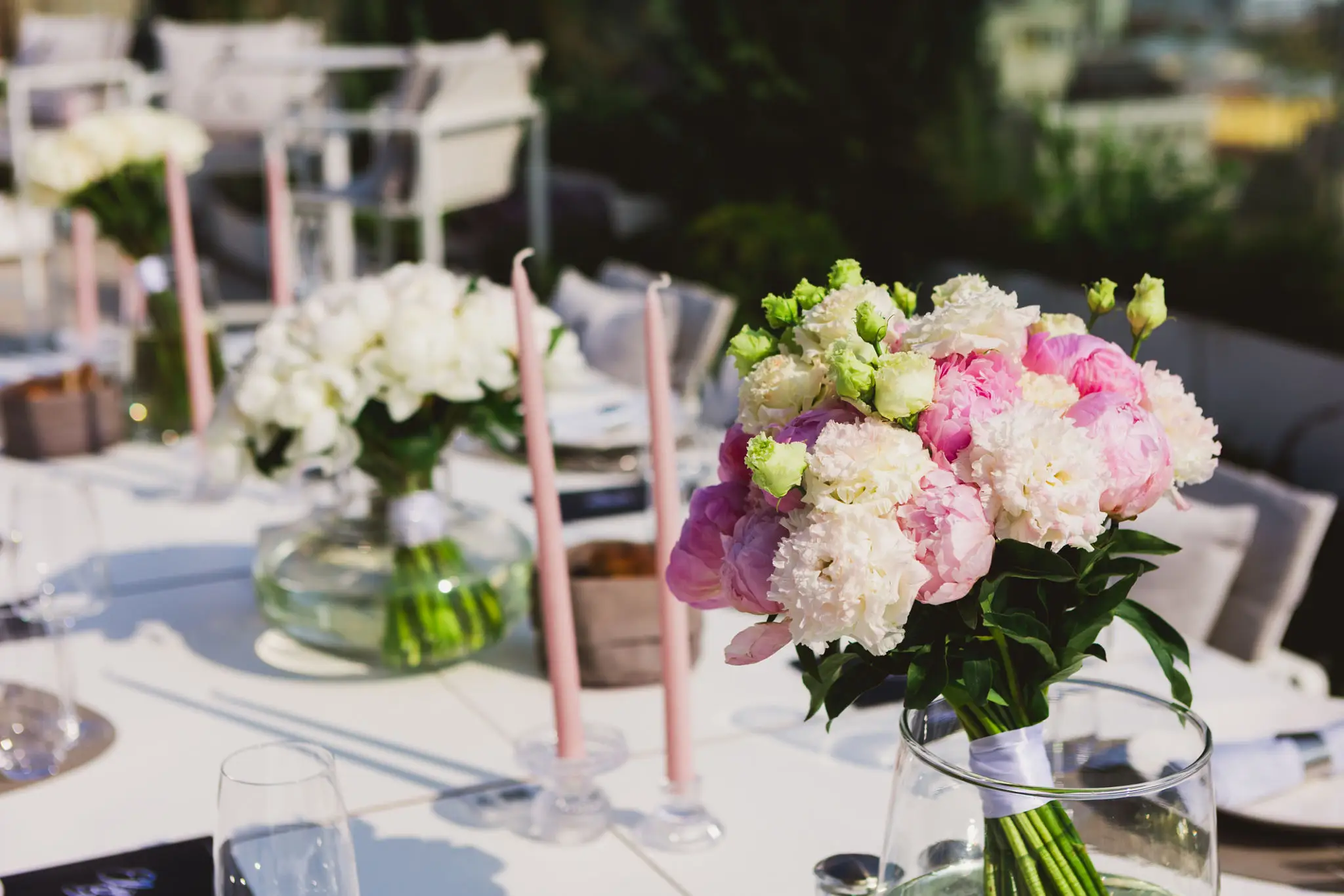 Elegant table setting with pink floral centerpieces.