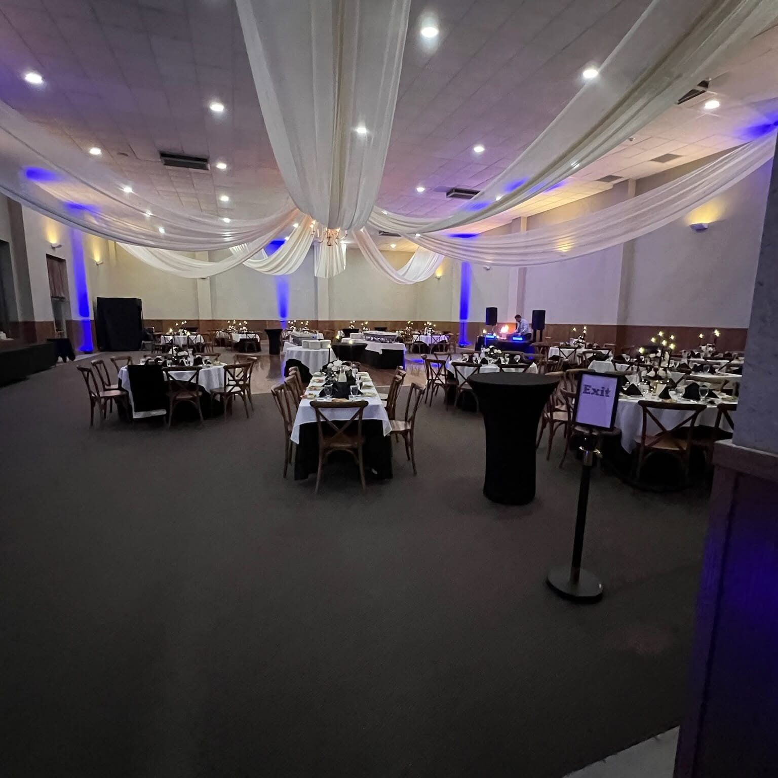 Elegant banquet hall with draped ceiling decor.