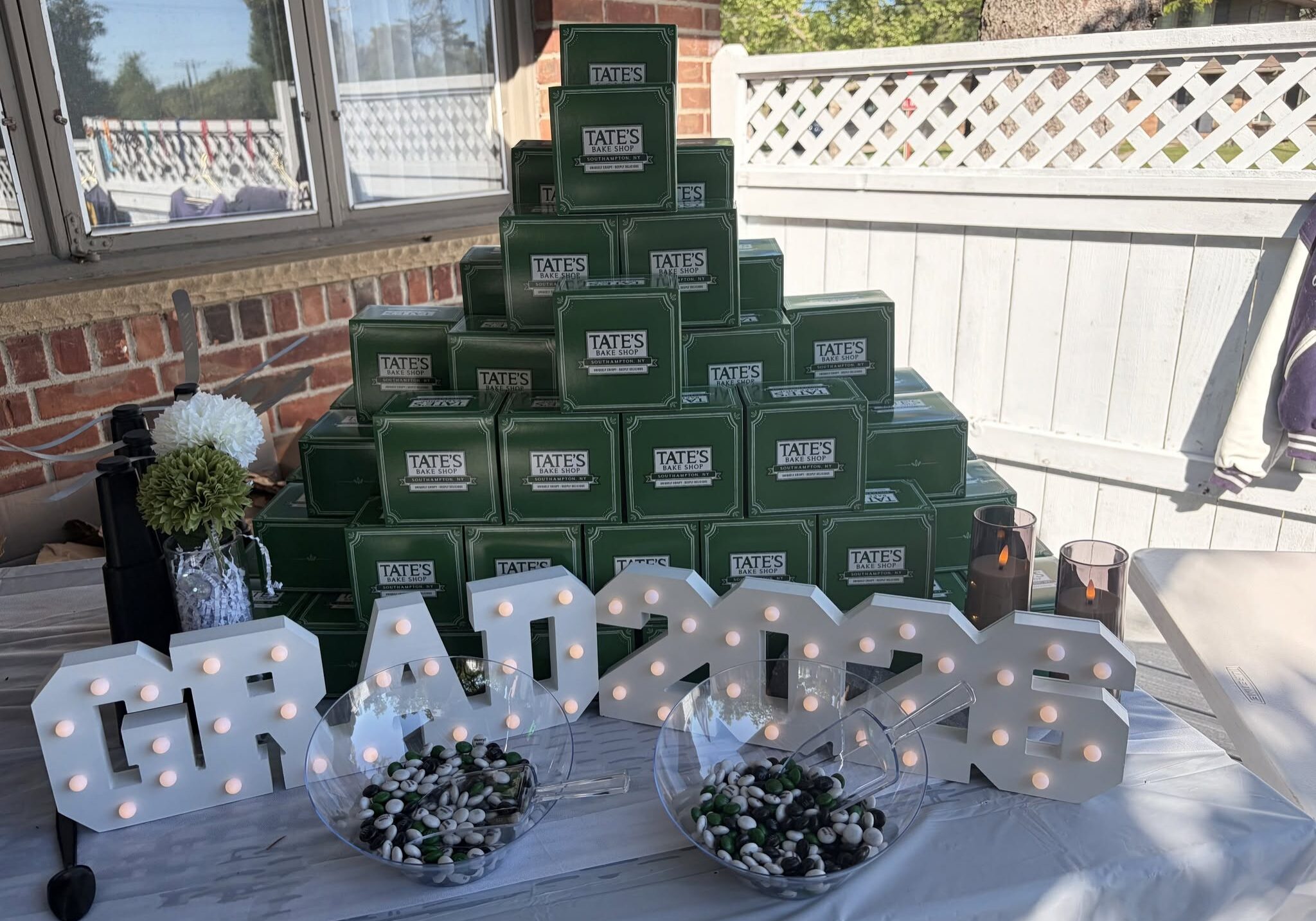 Graduation display with decorative boxes and lights.